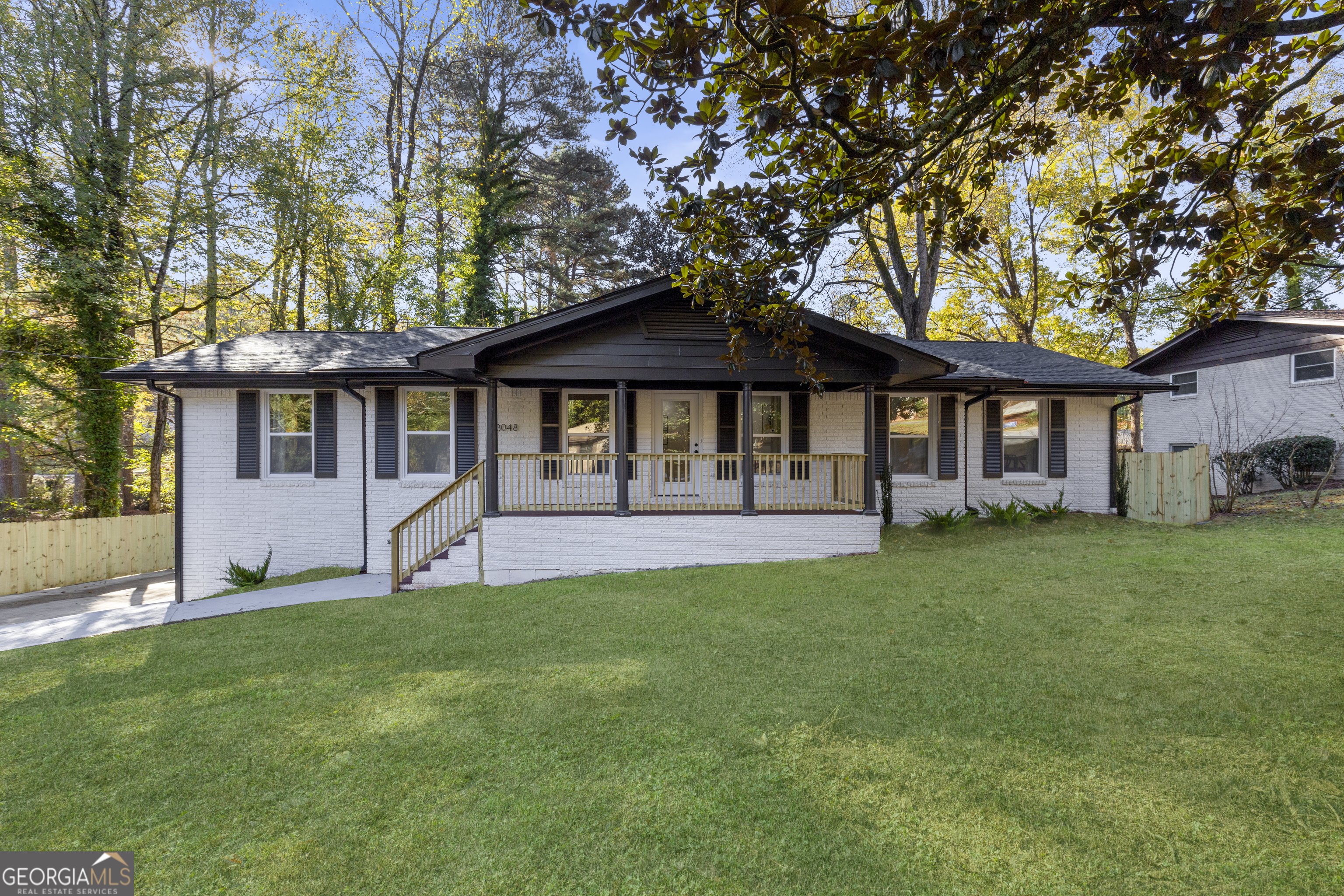 a front view of a house with a yard and porch