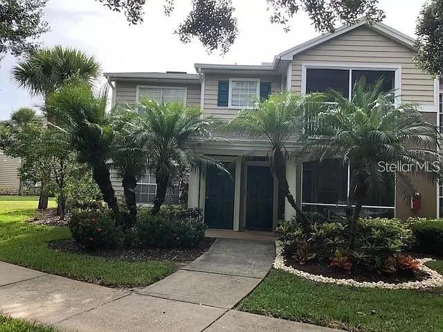 a front view of house with yard and green space