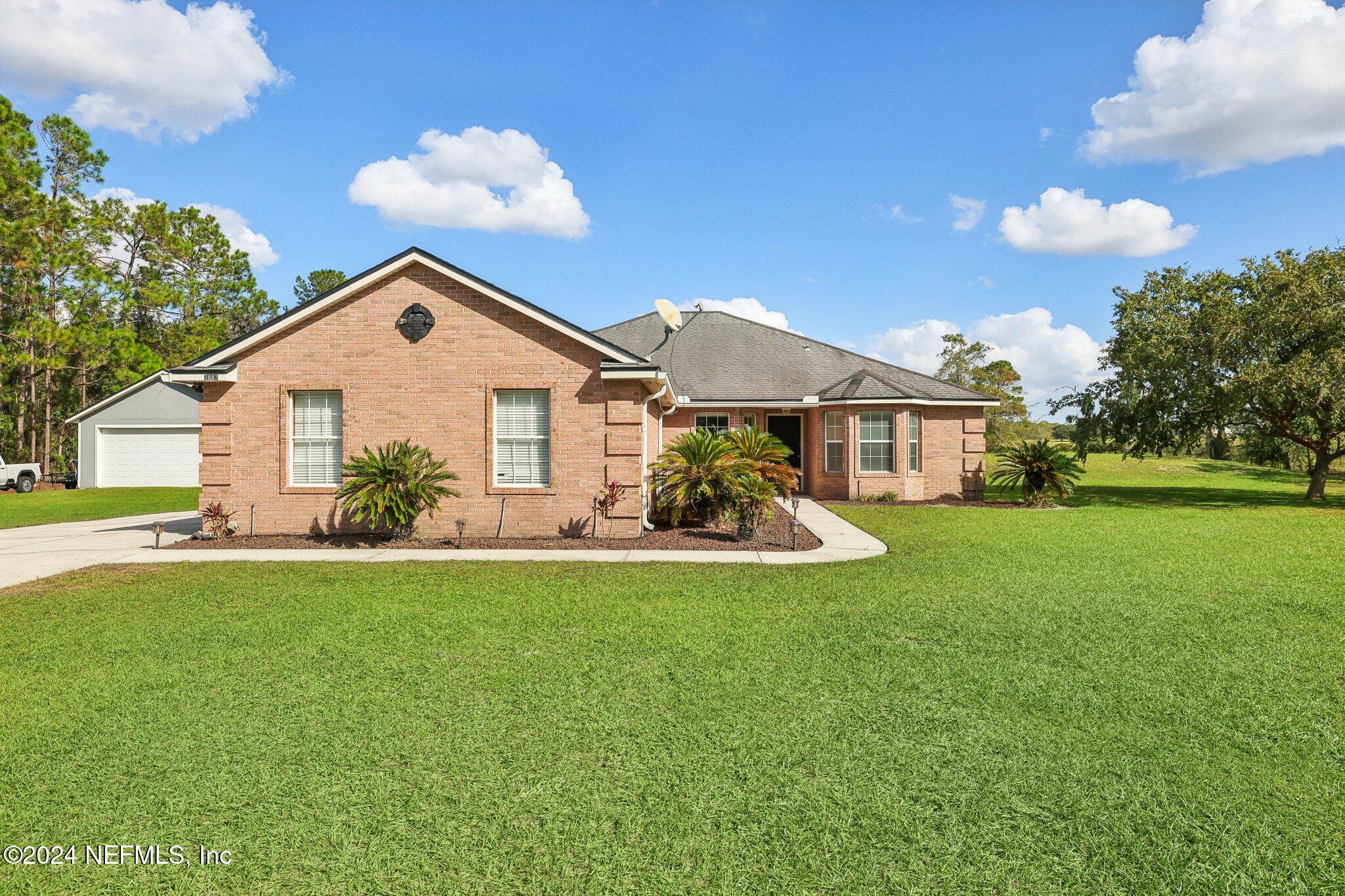 a view of a house with a yard