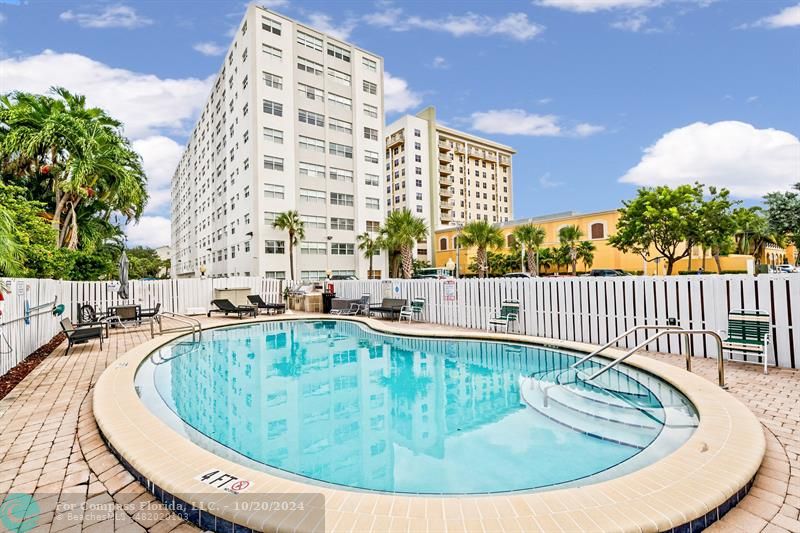 a view of a swimming pool with a lounge chairs