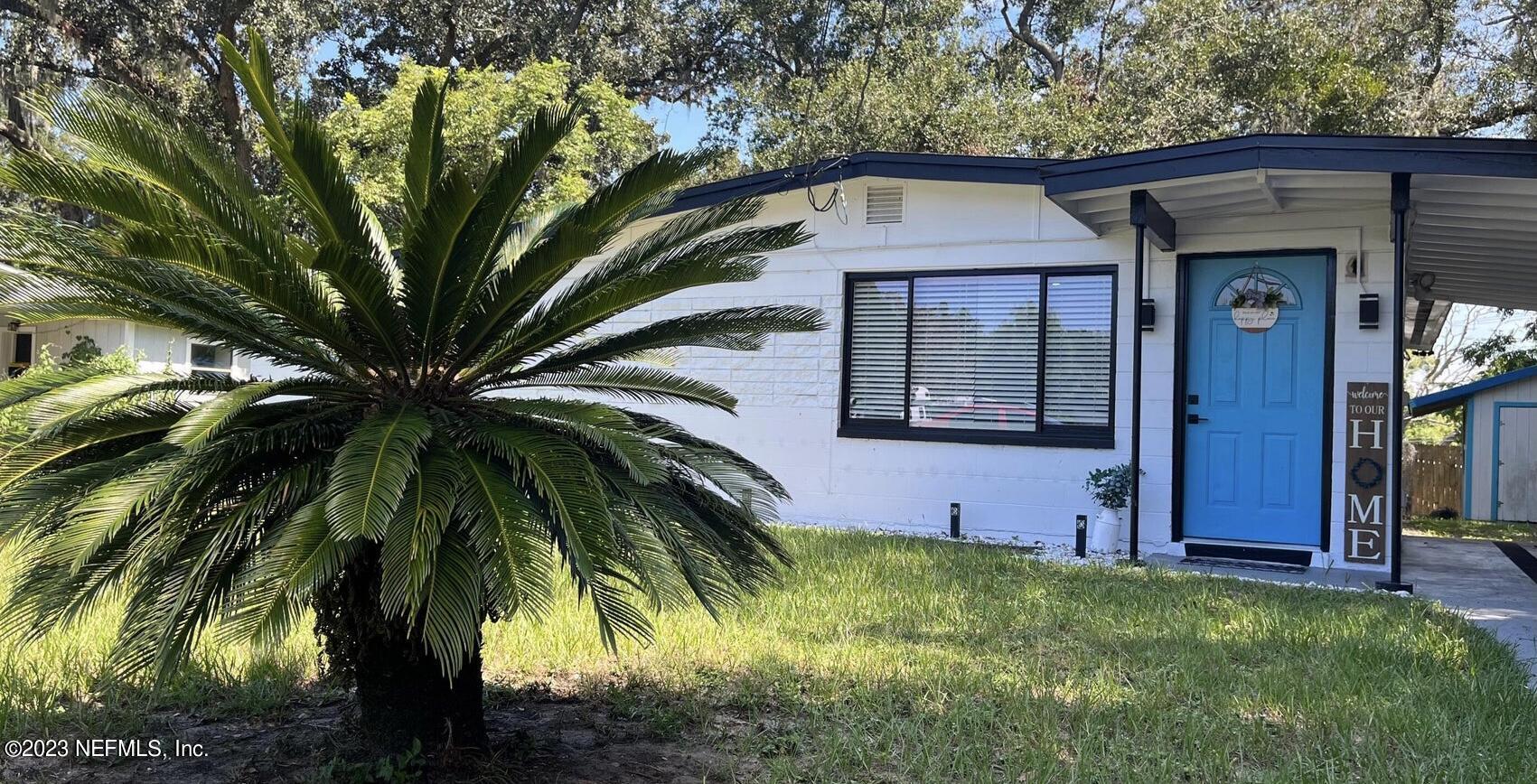 a view of a house with a small yard