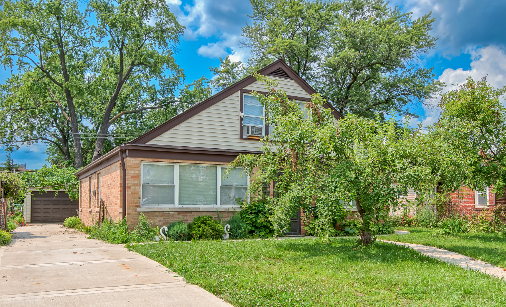 a front view of house with yard and green space