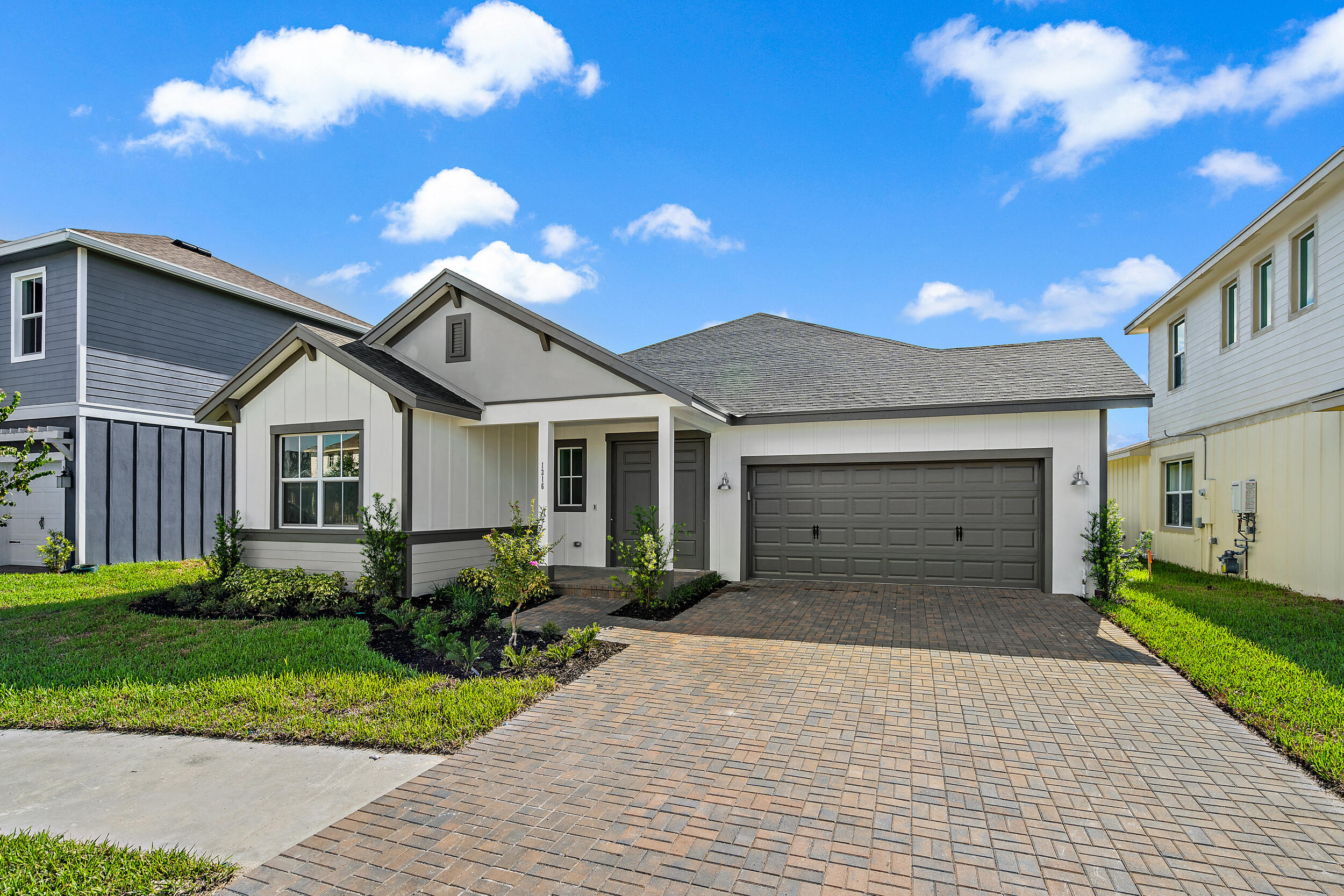 a front view of a house with a yard and garage