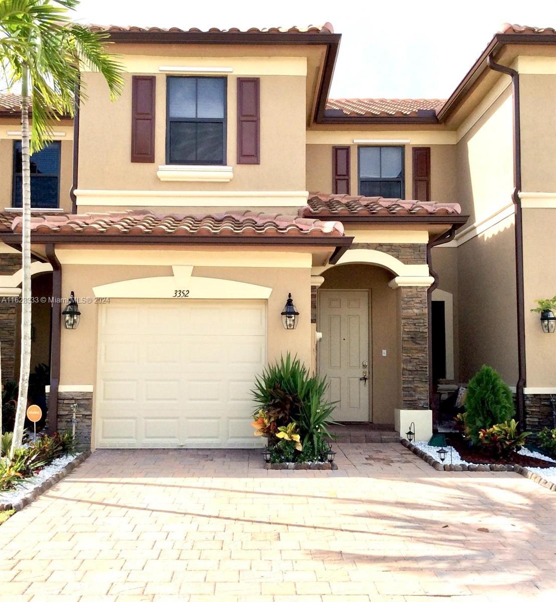 a front view of a house with garage