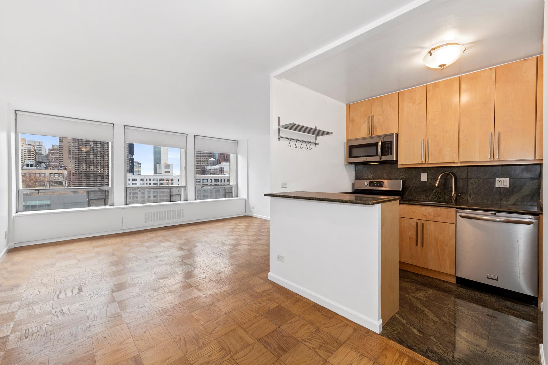 a kitchen with stainless steel appliances a refrigerator sink and microwave