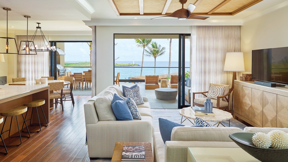 a living room with furniture a flat screen tv and a floor to ceiling window