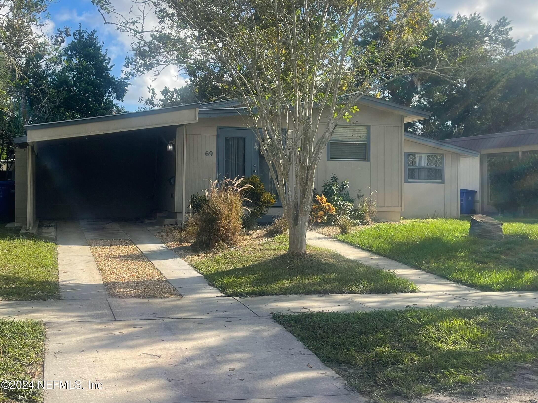 a backyard of a house with table and chairs