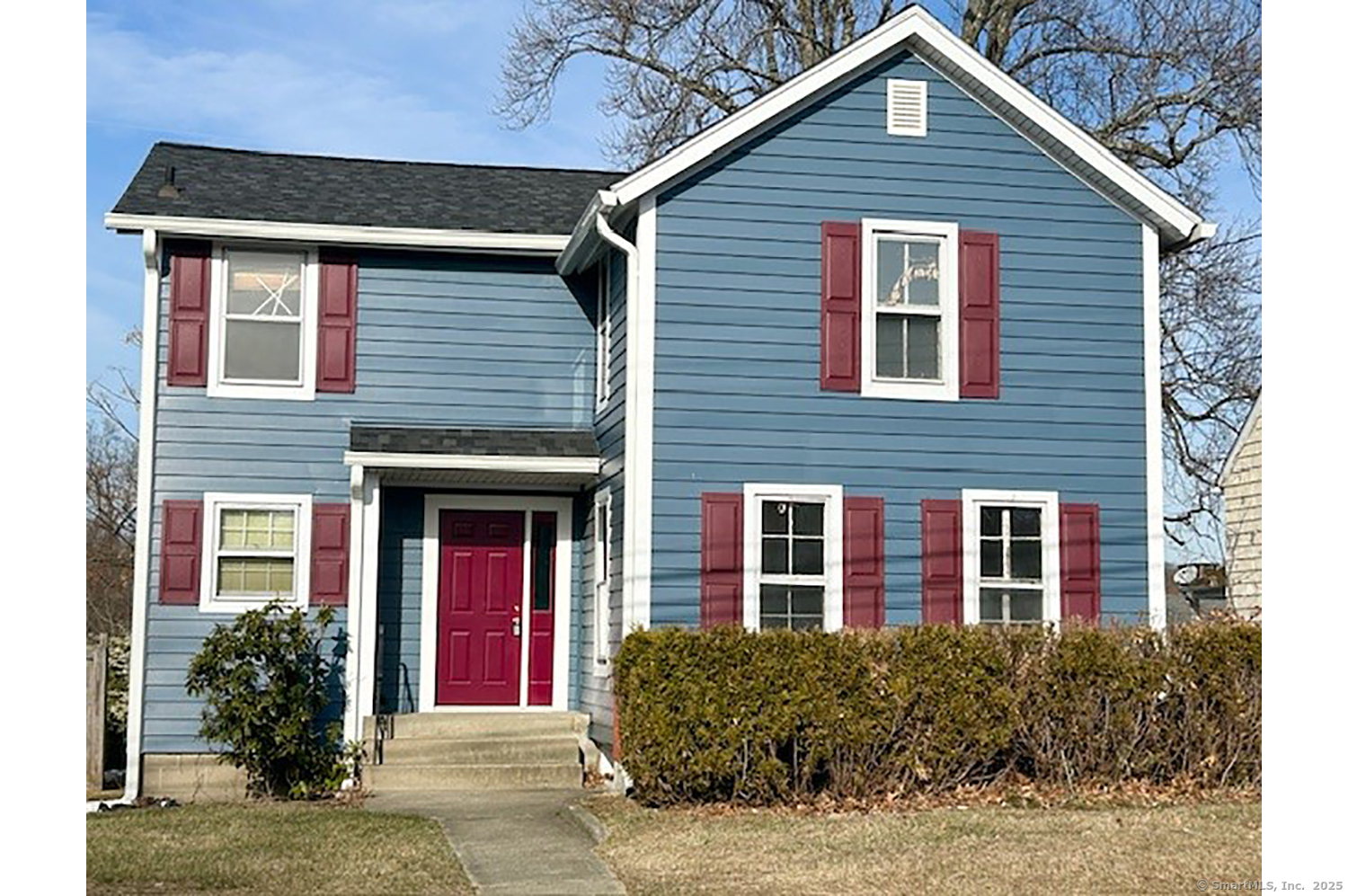 a view of a brick house with large windows