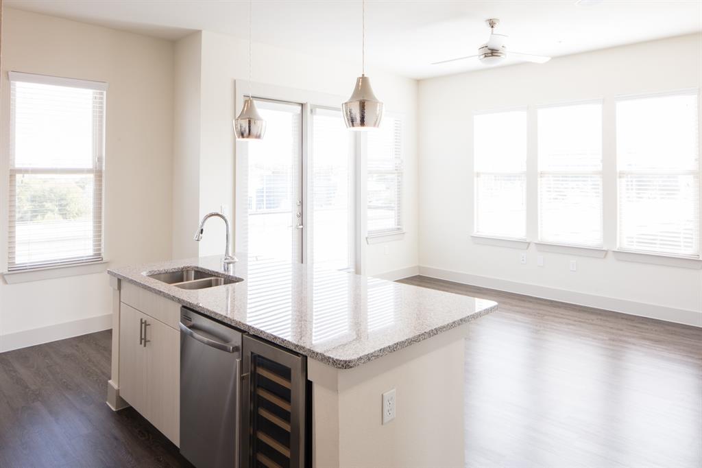 a kitchen with stainless steel appliances granite countertop a sink a stove and a window