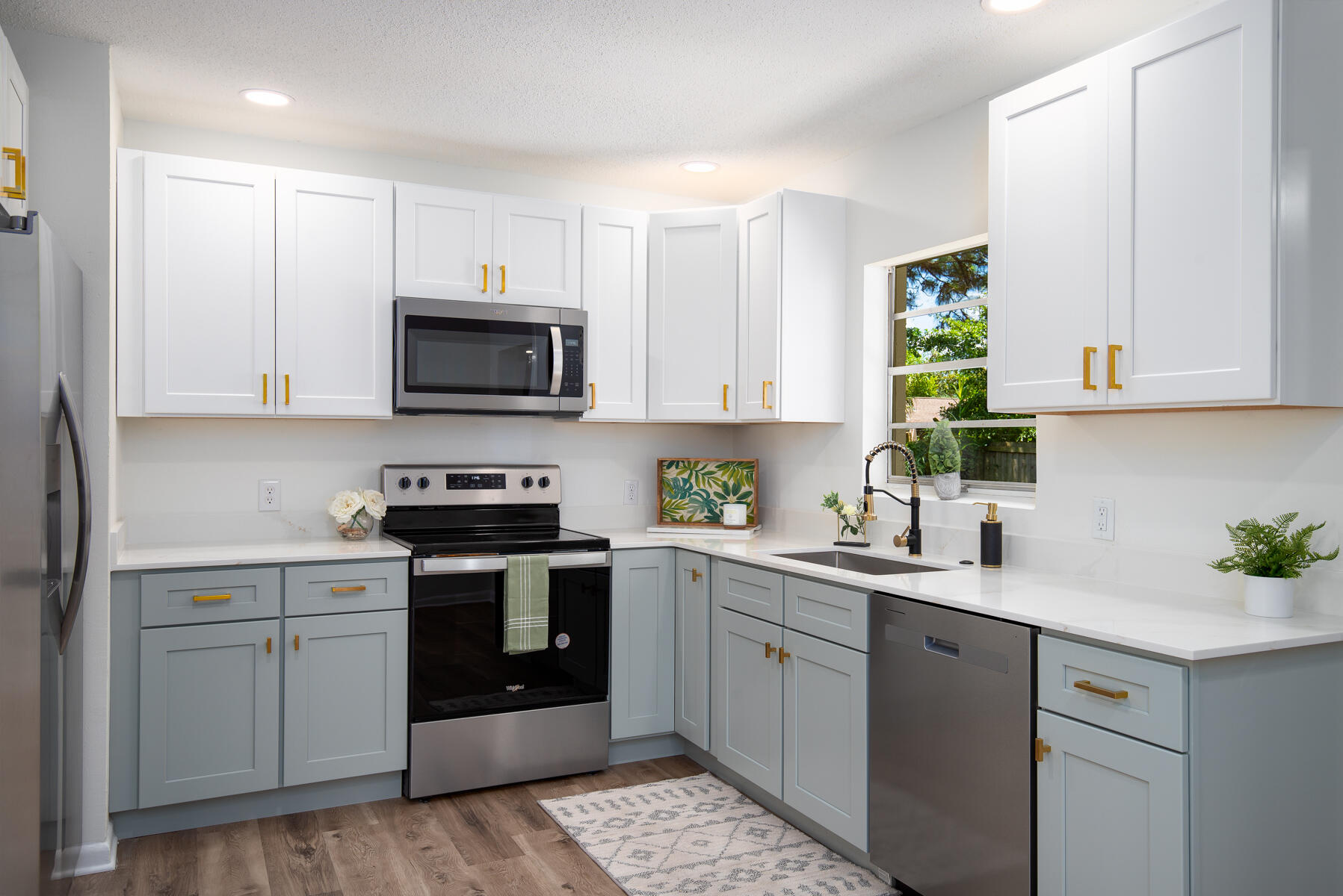 a kitchen with a sink stove and microwave