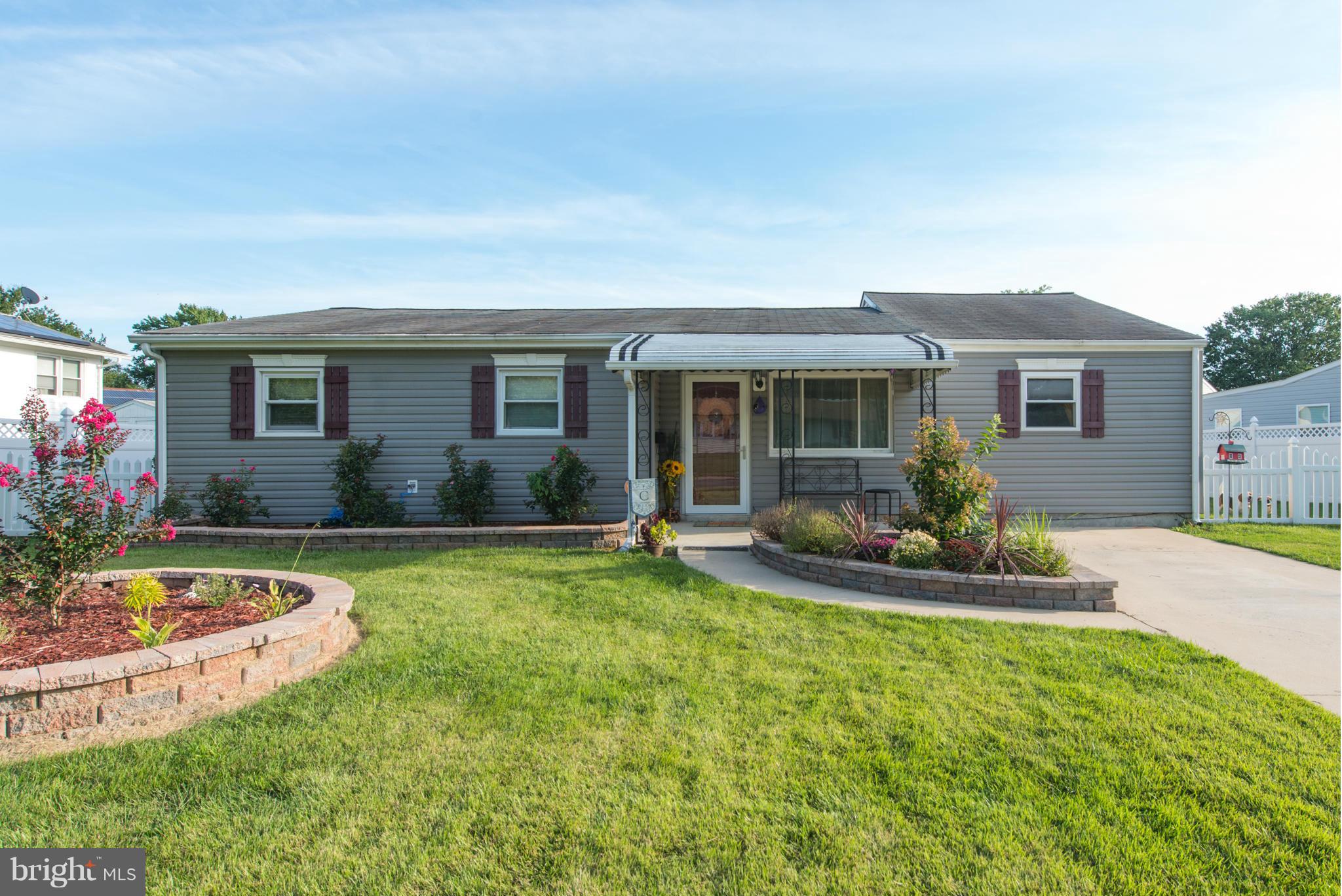 a front view of house with yard and outdoor seating