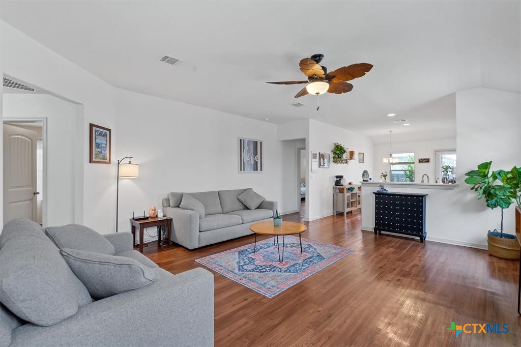 a living room with furniture a couch and a potted plant