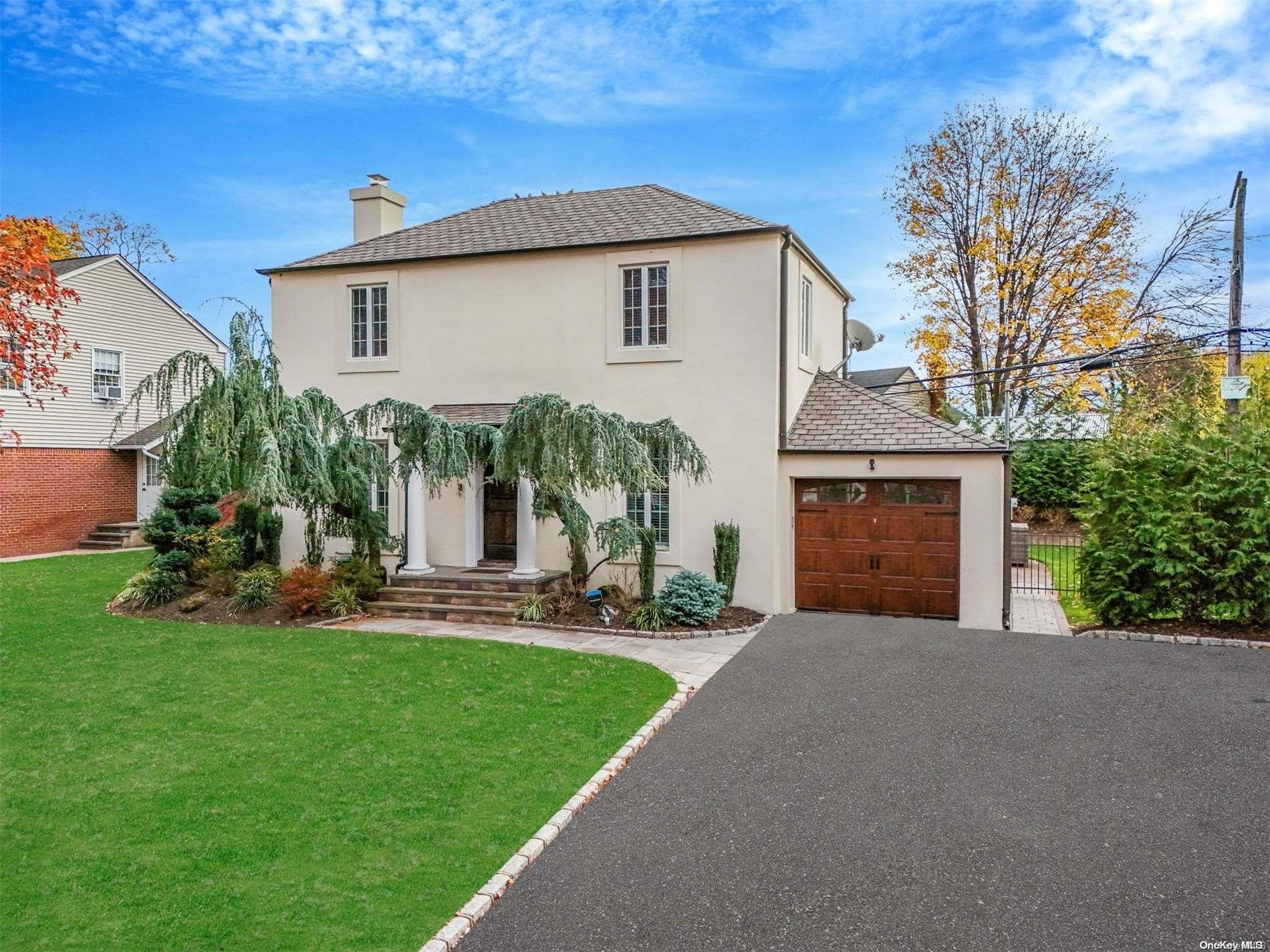 a view of a house with a yard and sitting area