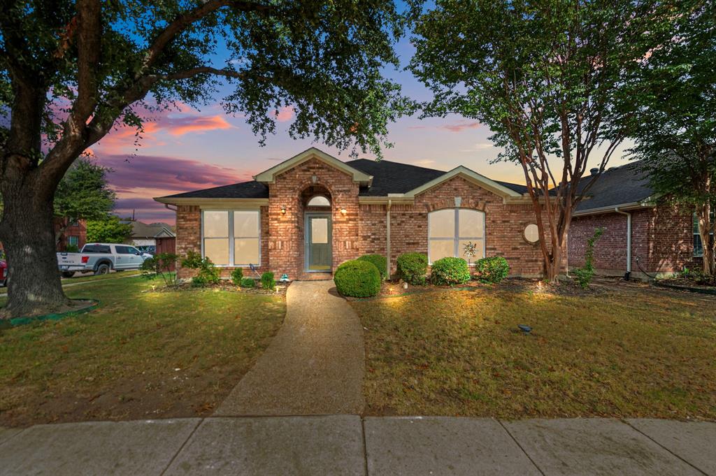 a front view of a house with yard porch and outdoor seating