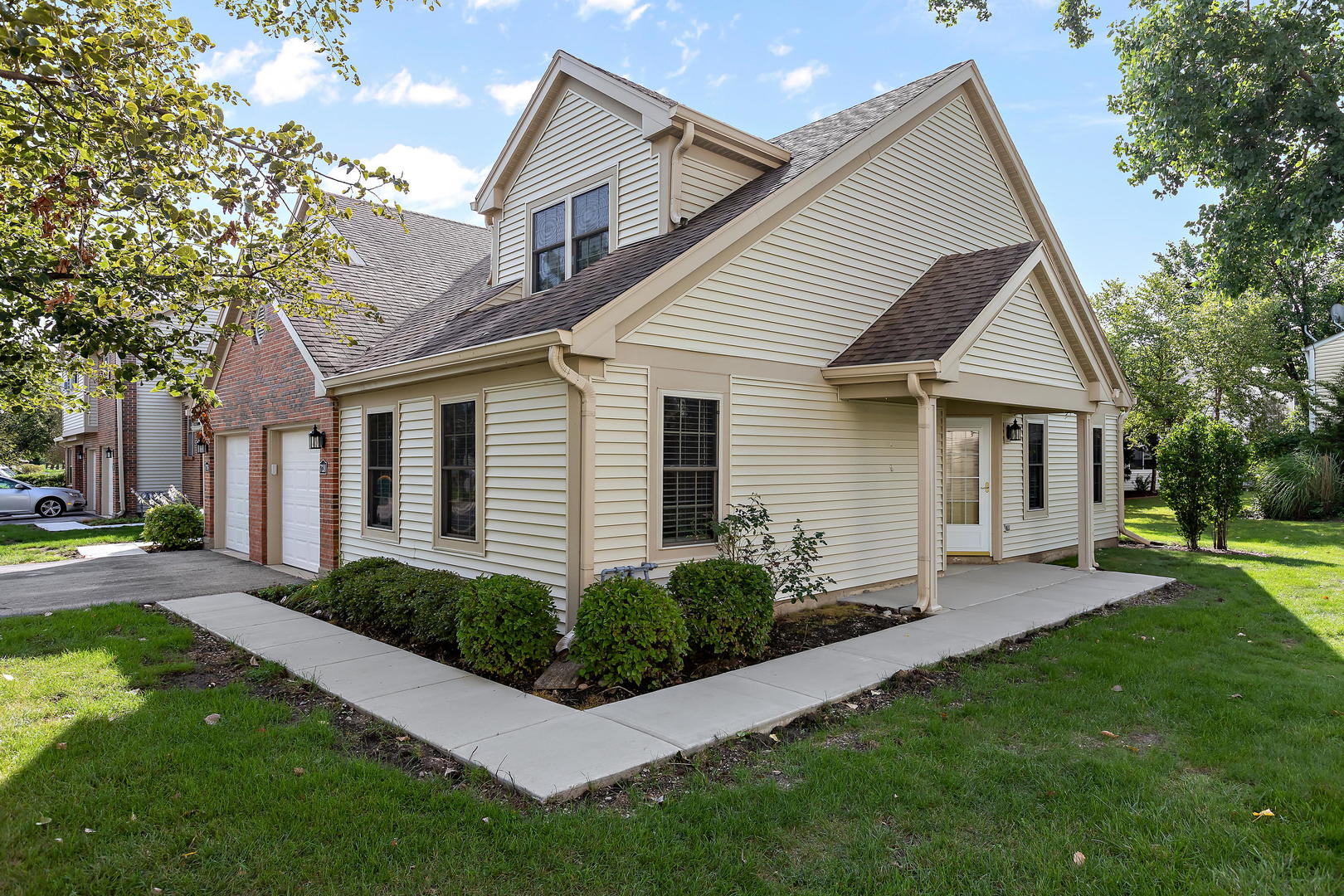 a front view of a house with a garden