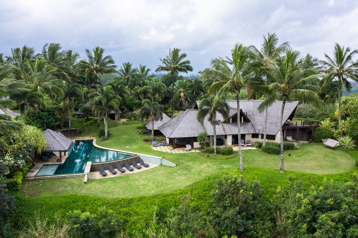 a view of a house with a yard and sitting area