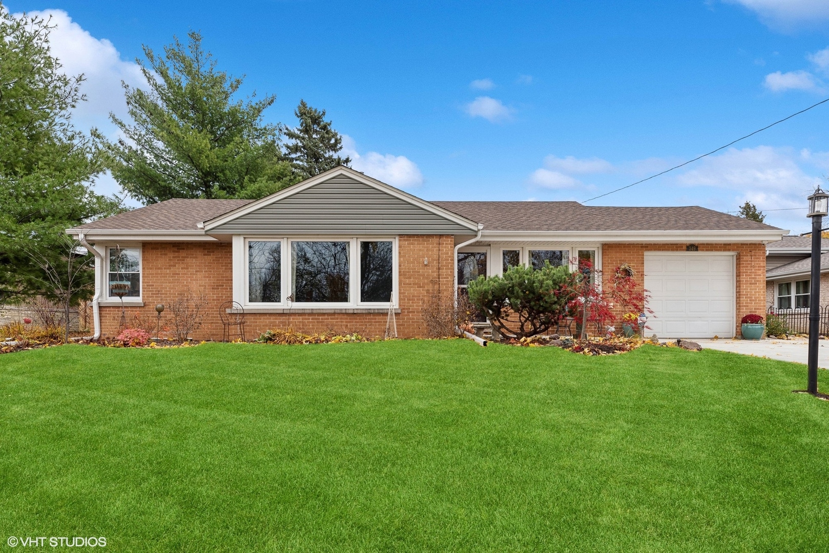 a front view of a house with a garden