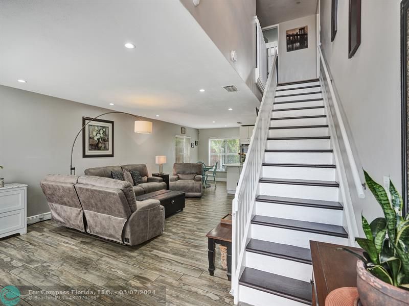 a living room with furniture and stairs