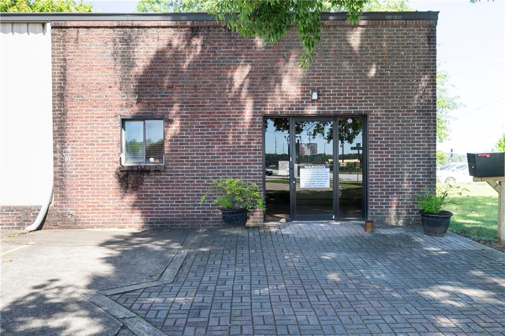 a view of a brick house with many windows