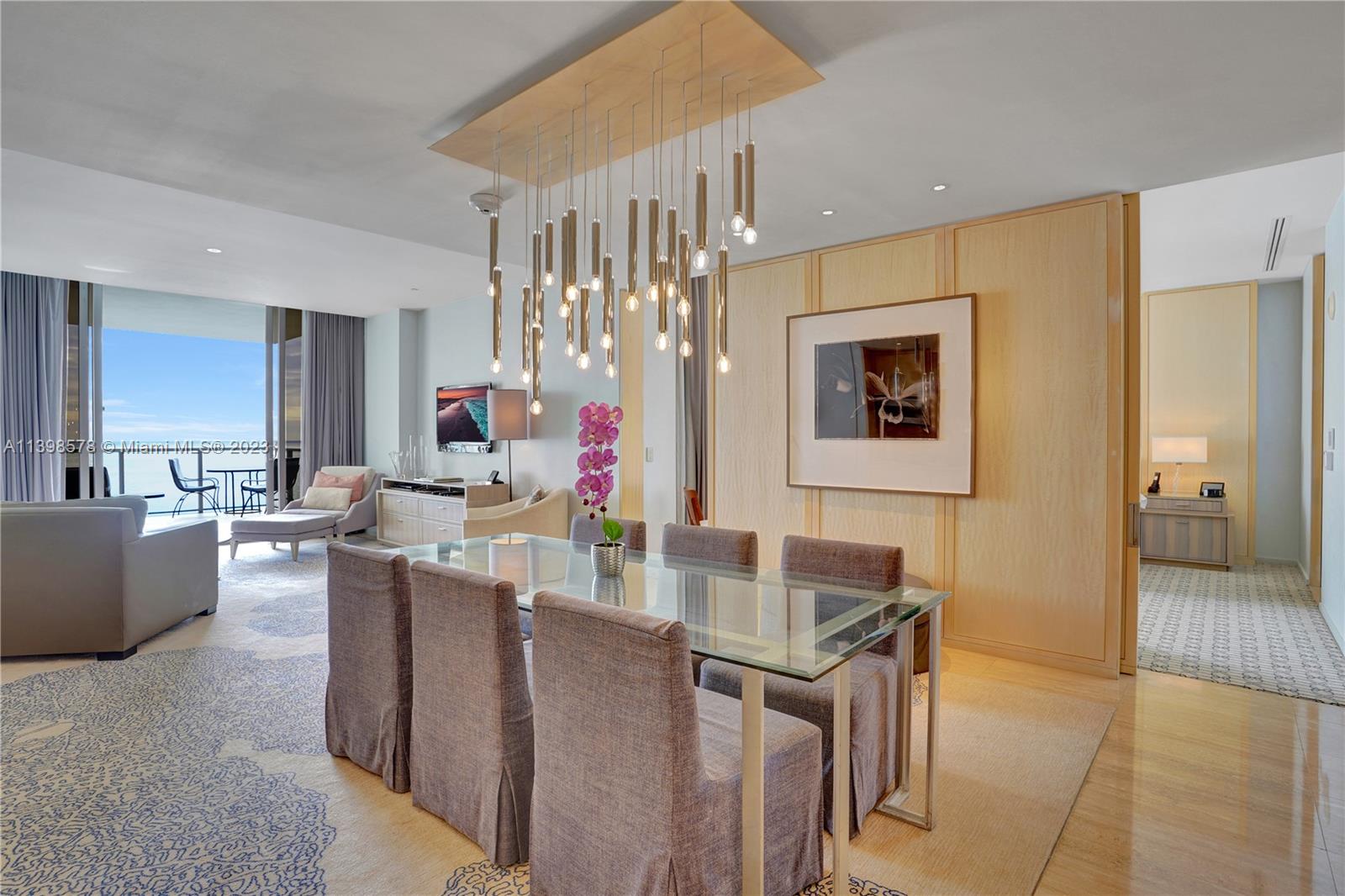 a living room with couches and kitchen view