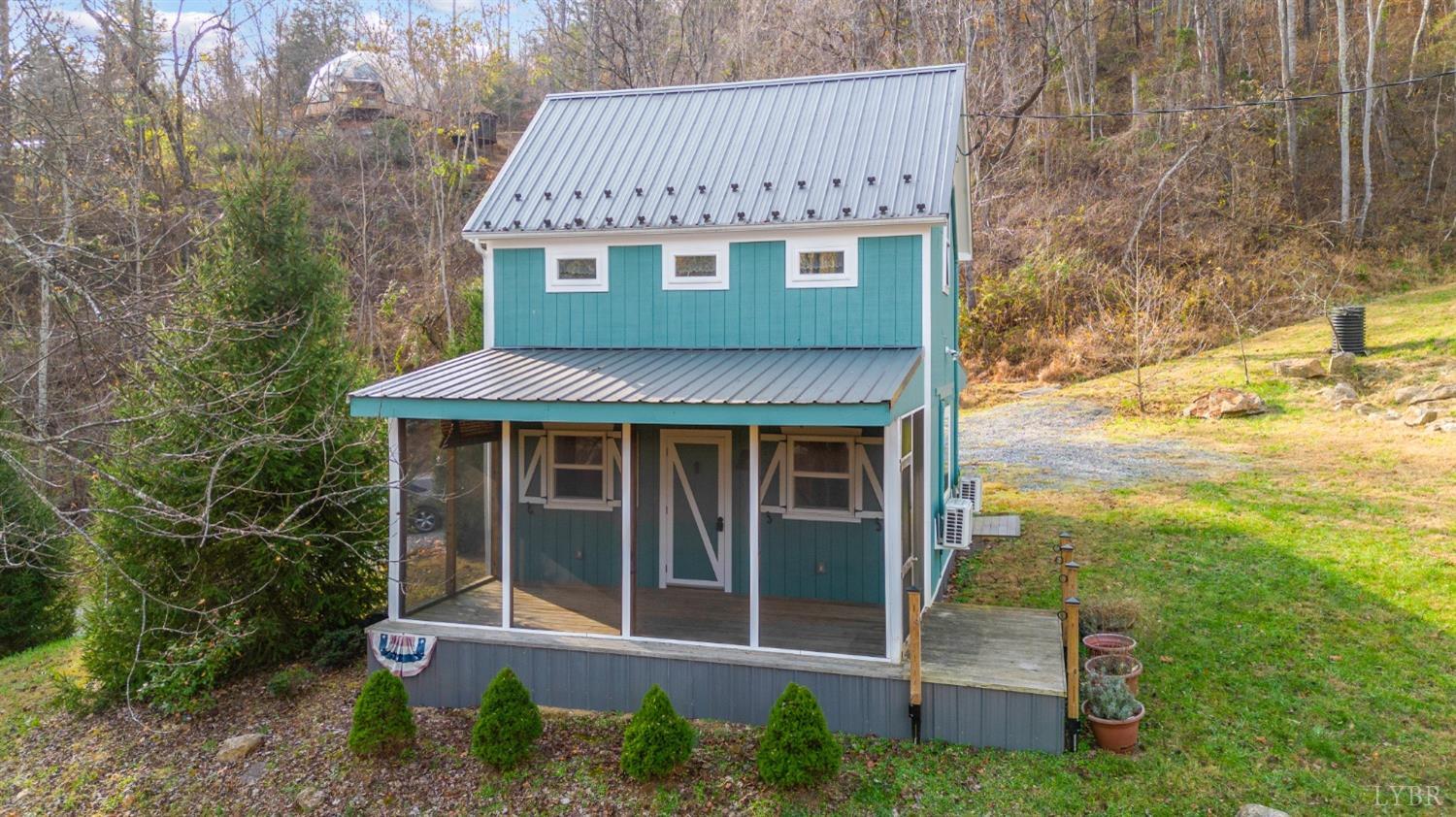 a view of a house with backyard porch and sitting area