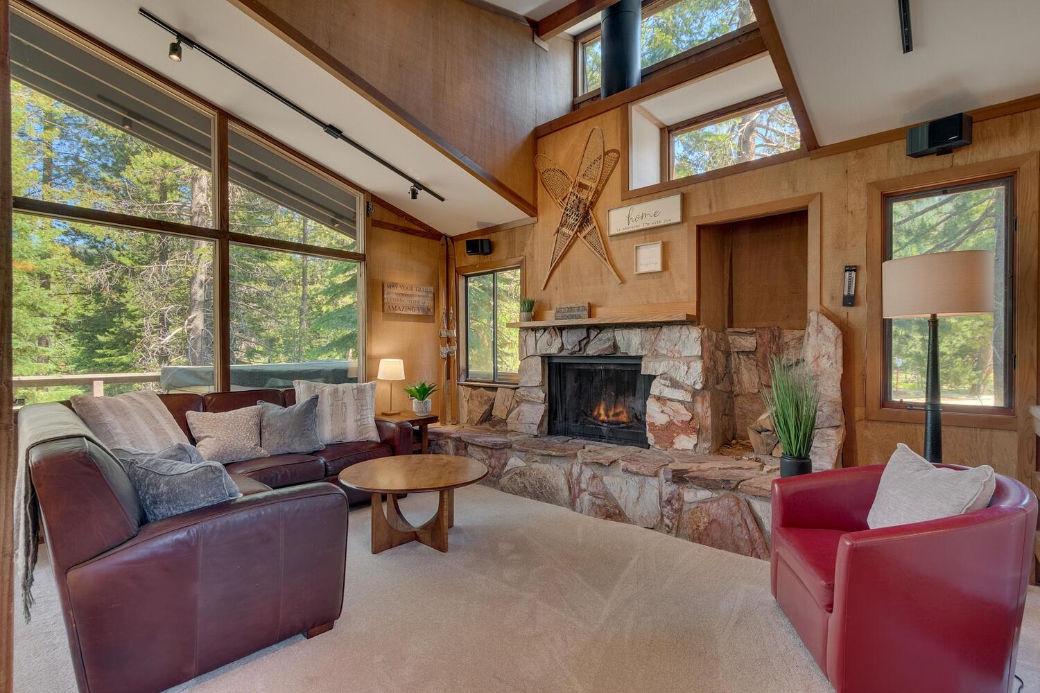 a living room with furniture a fireplace and a large window