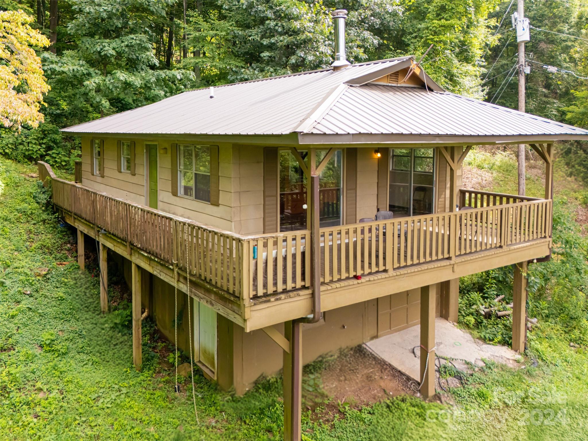 a view of a house with a yard and deck