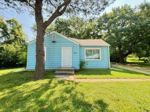 a view of a house with pool and a yard