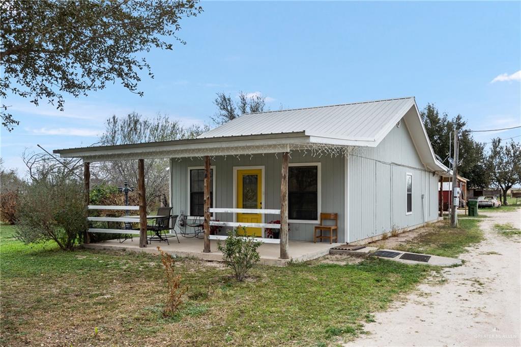 a view of a house with a backyard porch and sitting area