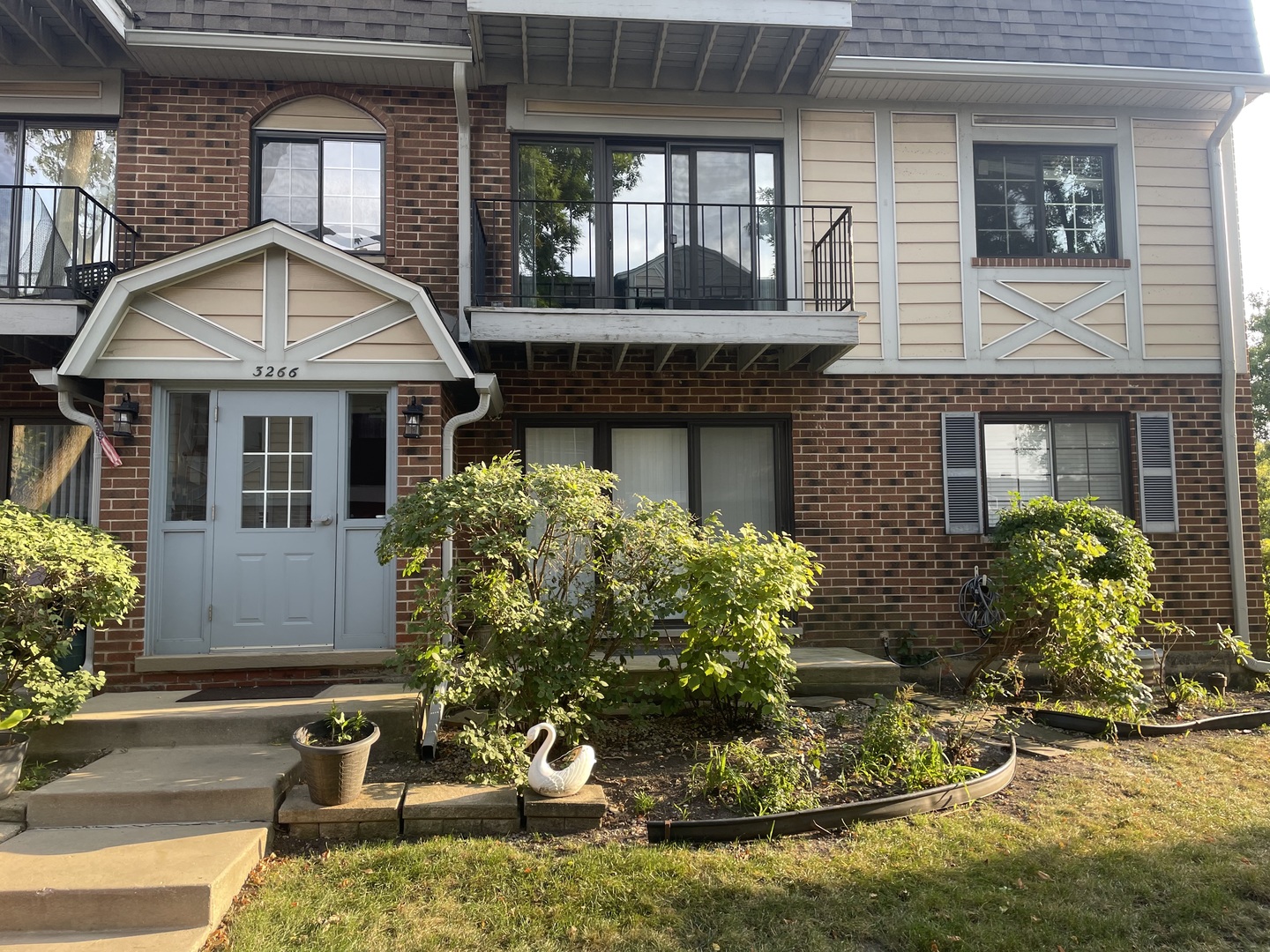 a front view of a house with garden