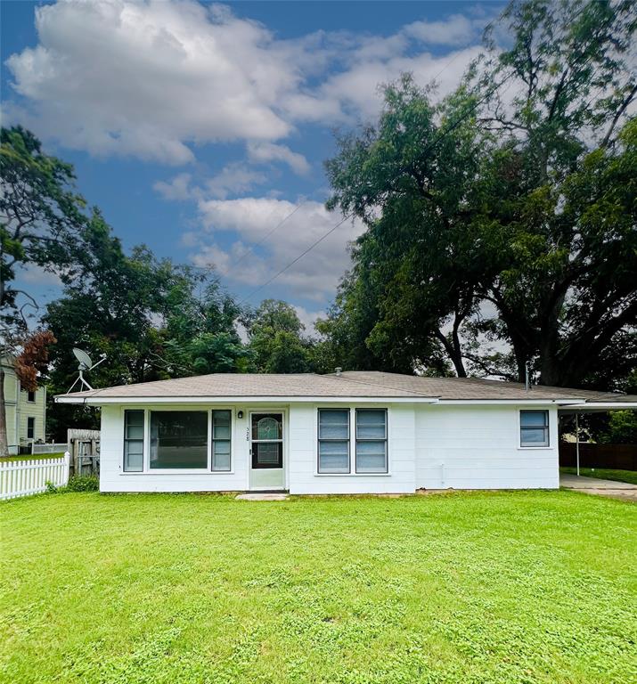 front view of a house with a garden