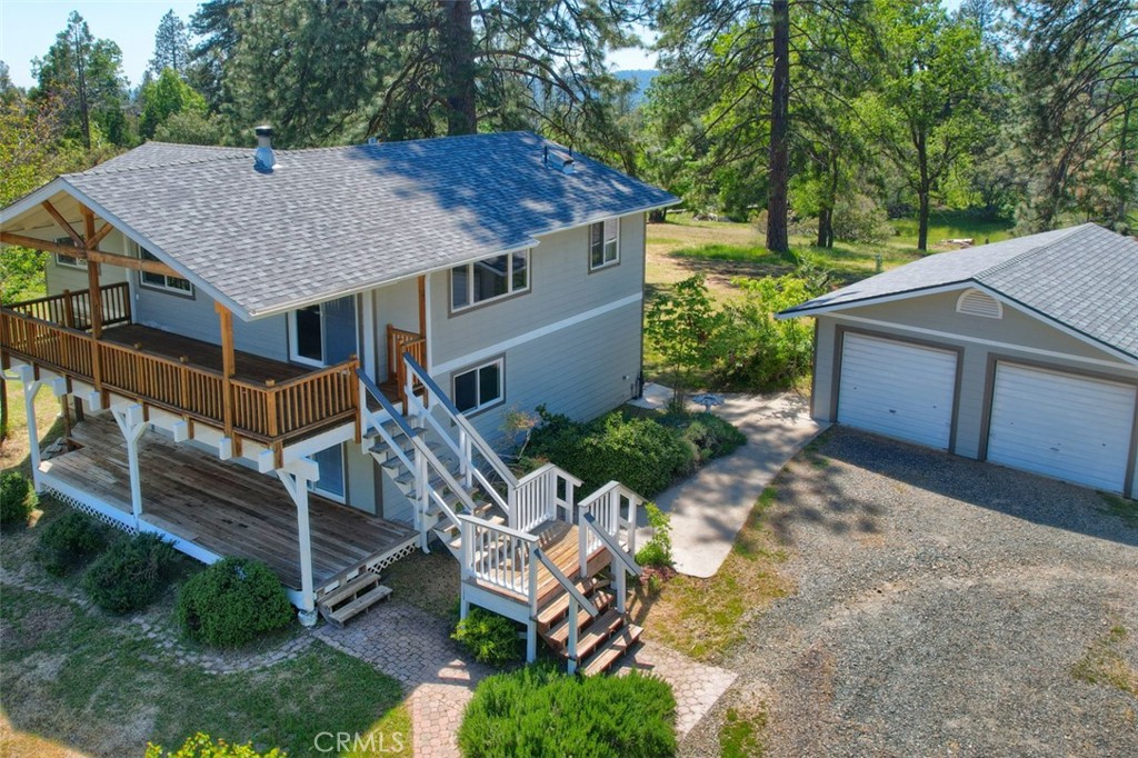 a aerial view of a house with table and chairs under an umbrella