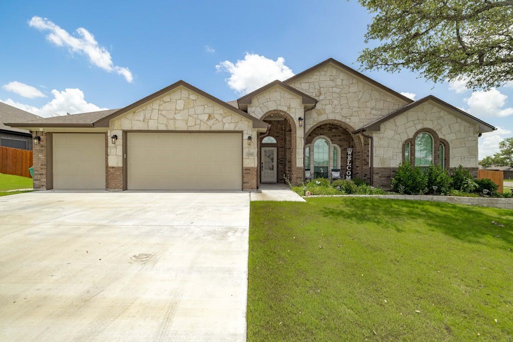 a front view of house with yard and green space