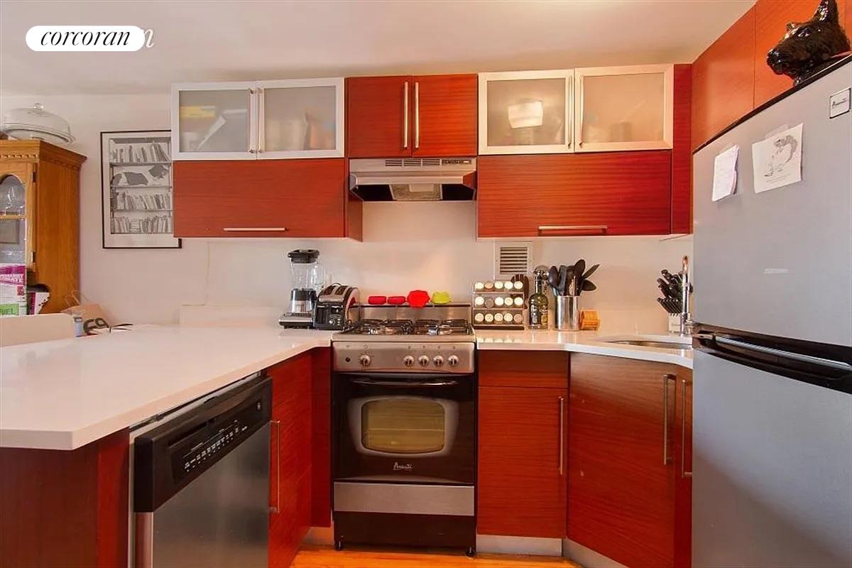 a kitchen with stainless steel appliances a stove a sink and a refrigerator