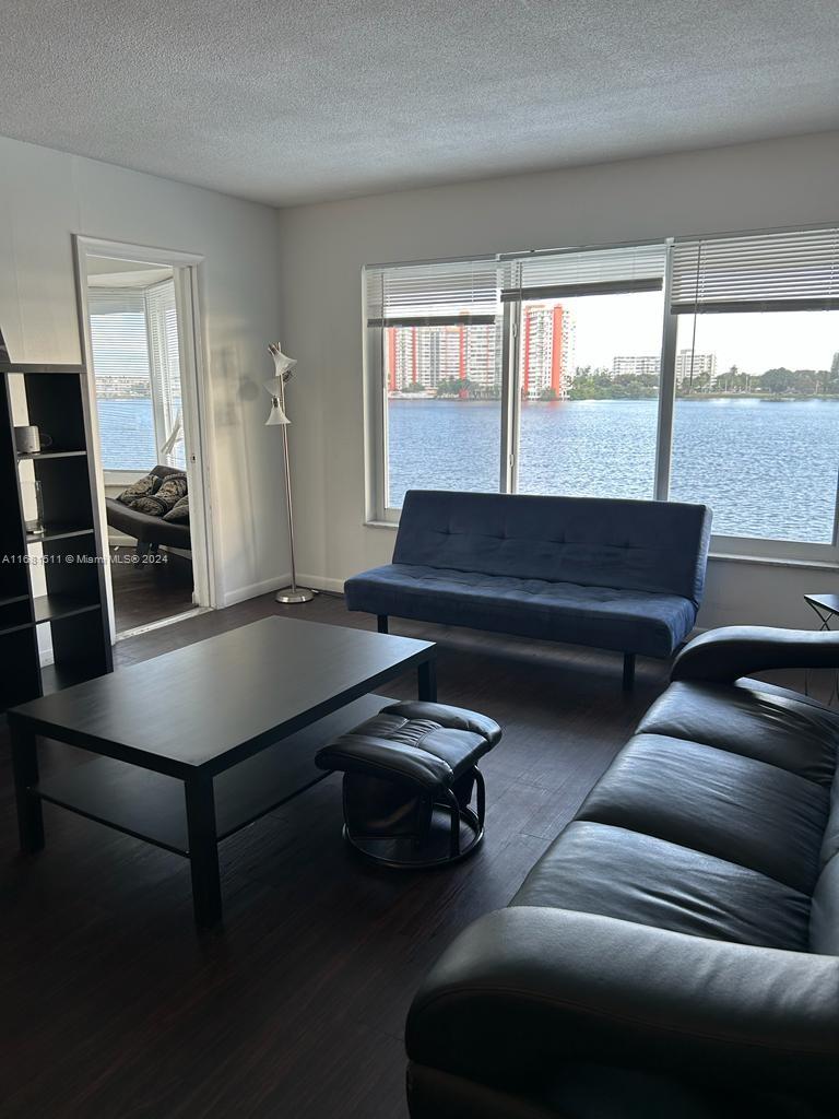 a living room with furniture and a floor to ceiling window