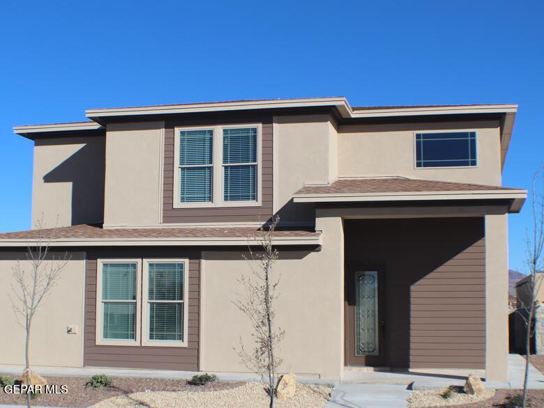 a front view of a house with garage