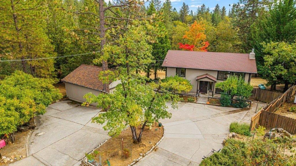 a aerial view of a house with a yard and sitting area