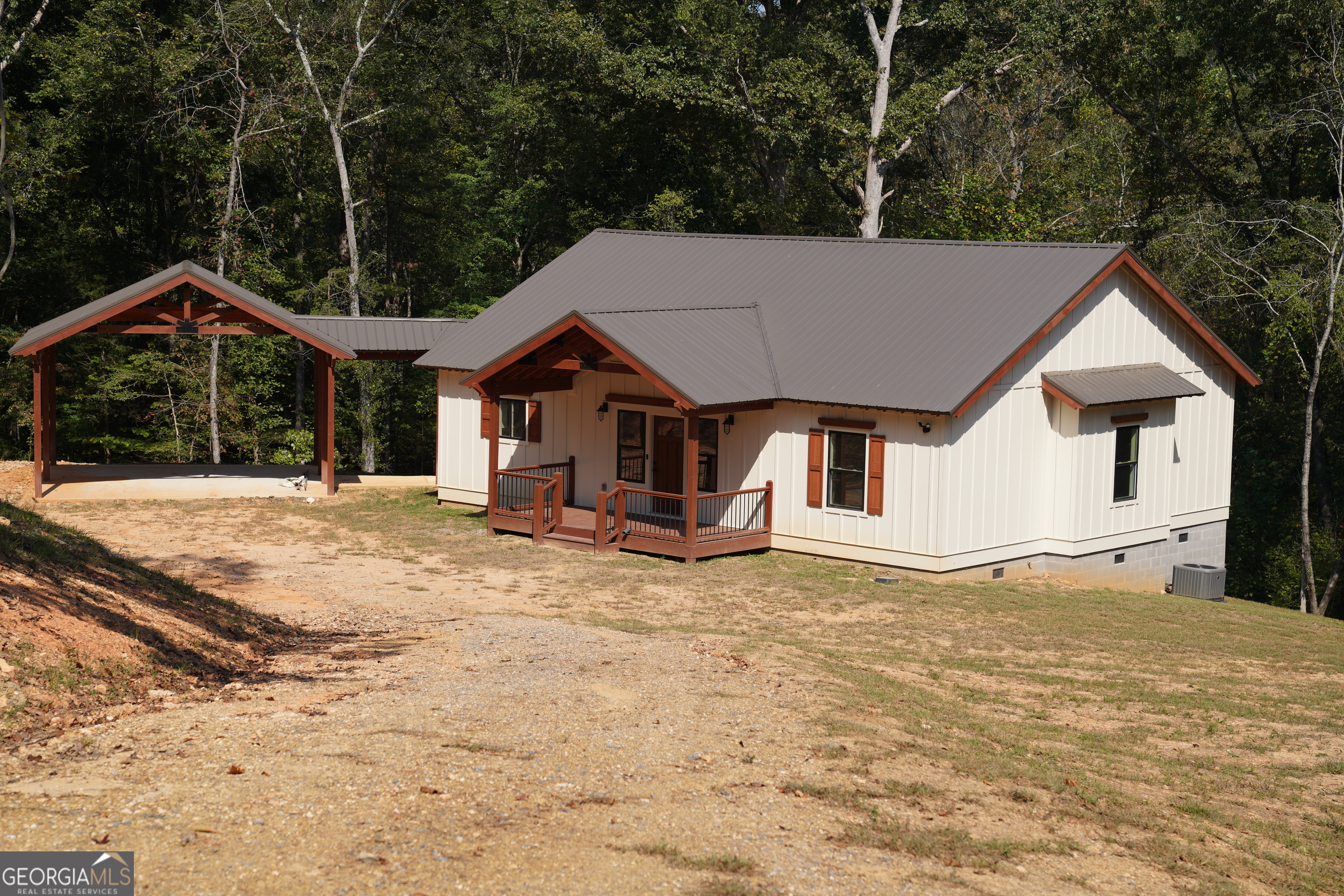 a view of a house with a yard and large tree