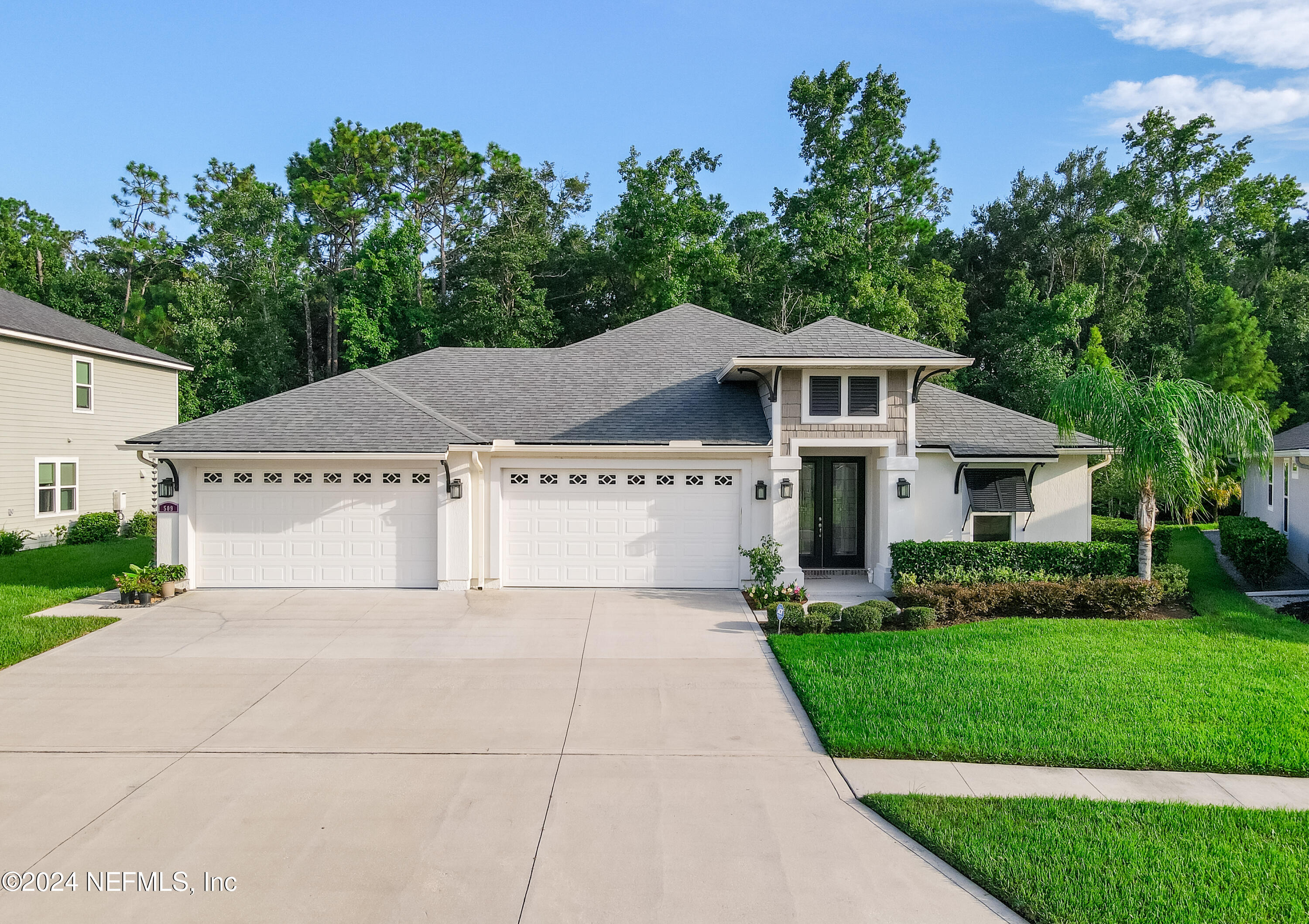 a front view of a house with a garden