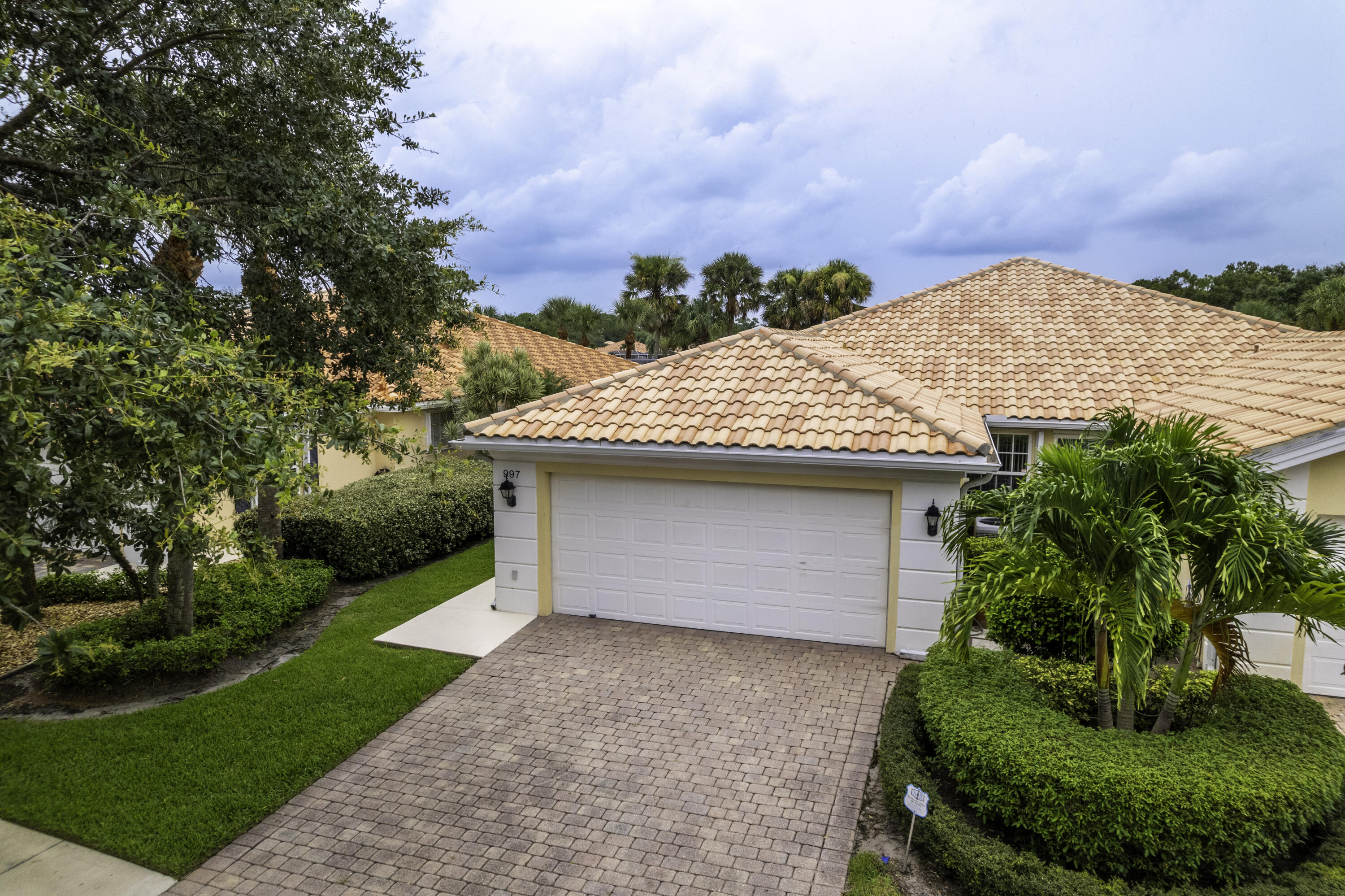 a front view of house with yard and trees around