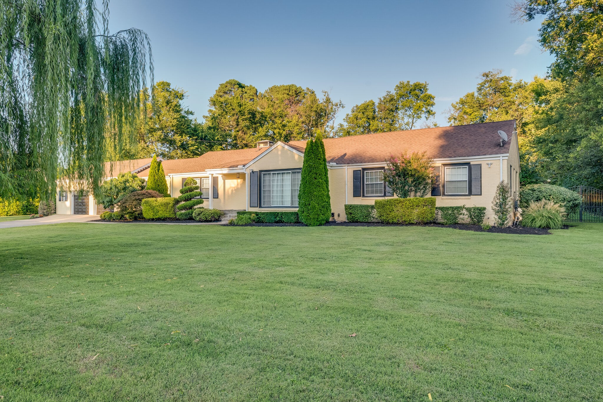 a front view of house with yard and green space