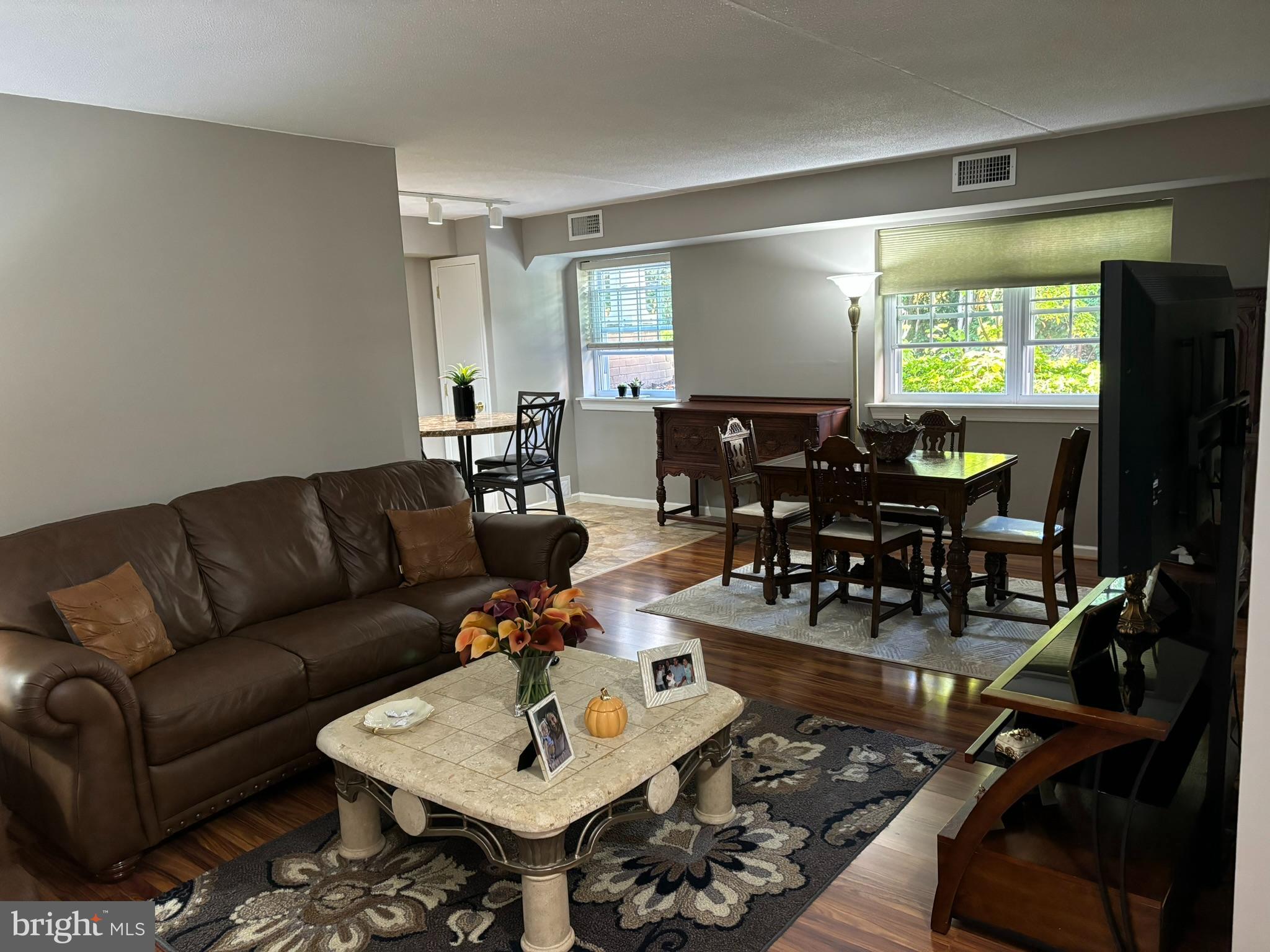 a living room with furniture and wooden floor