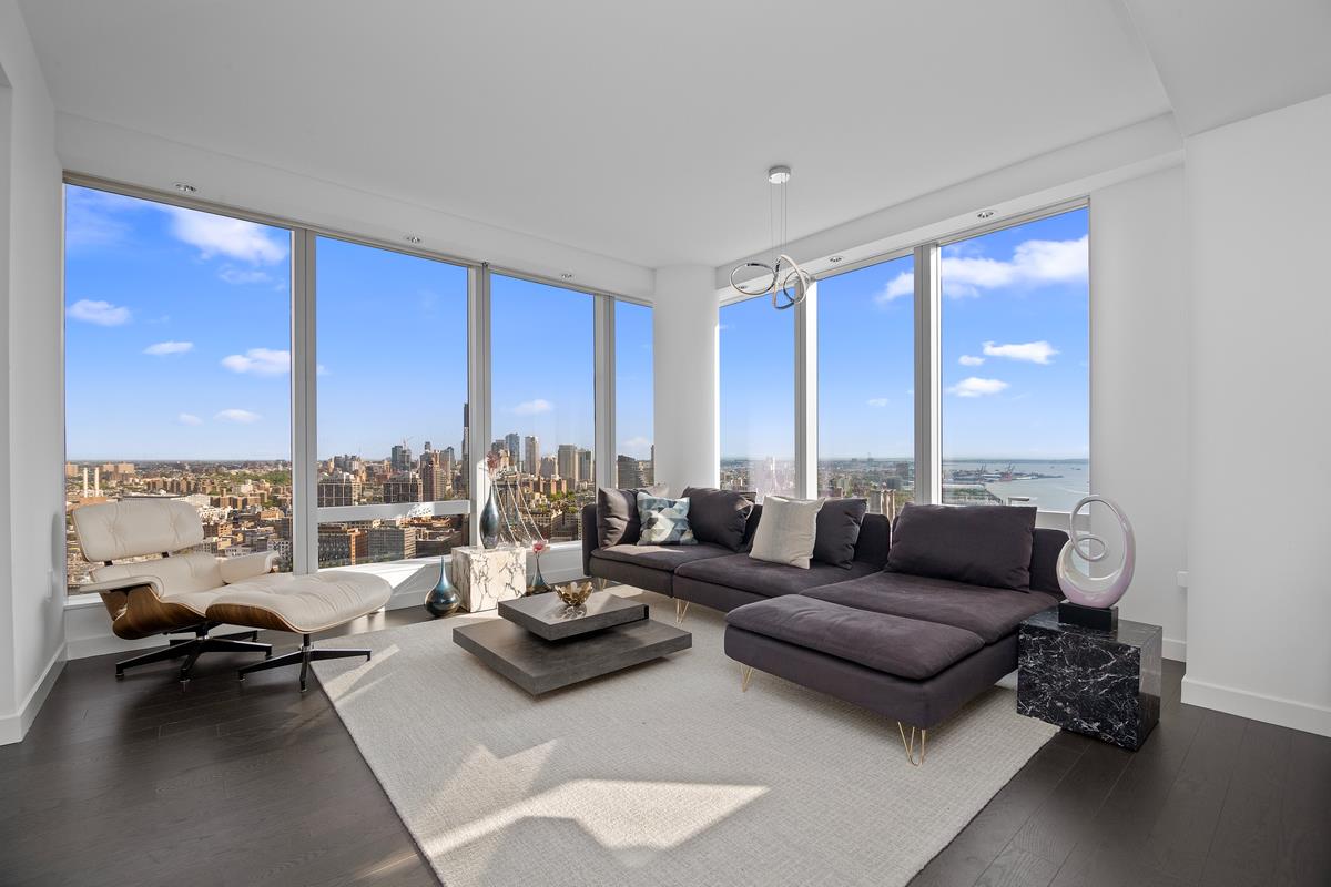 a living room with furniture and floor to ceiling window