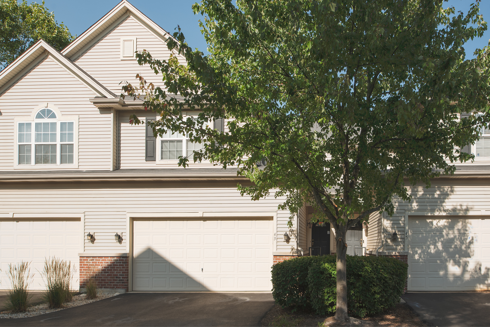 a view of a house with a tree and front view of a house