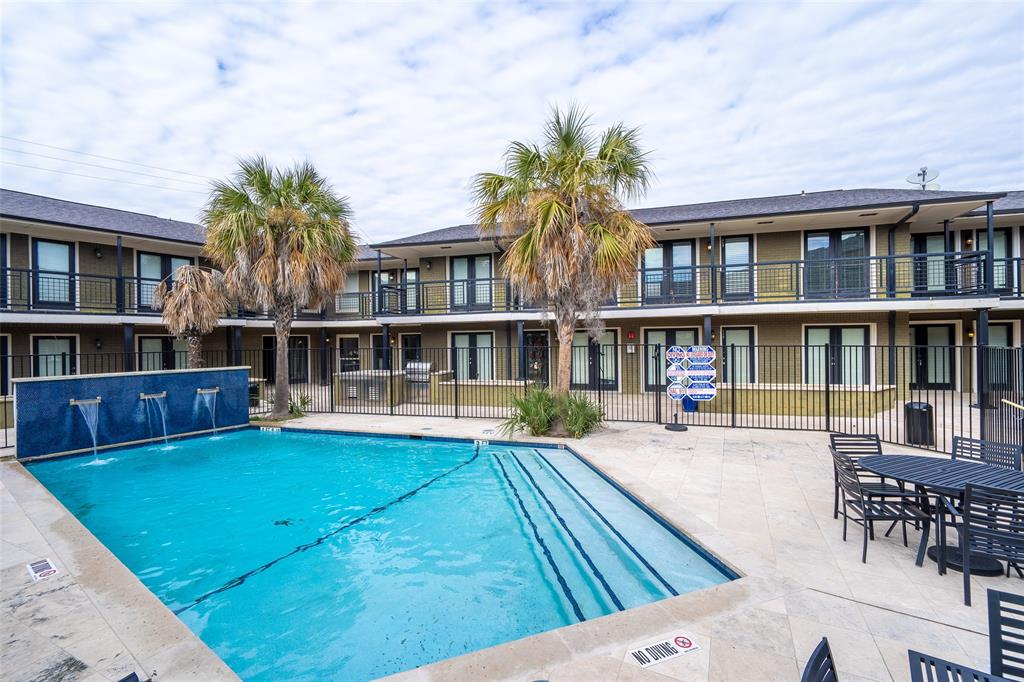 a view of house with swimming pool outdoor seating