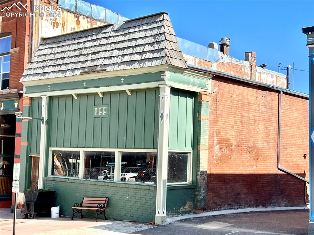 a view of building with a window and brick walls