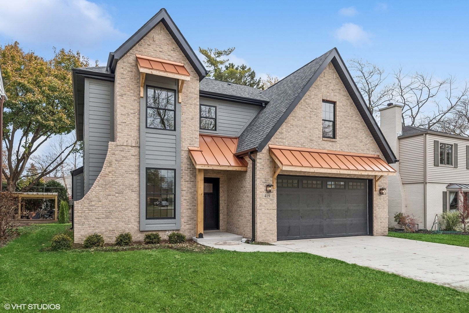 a front view of a house with a yard and garage