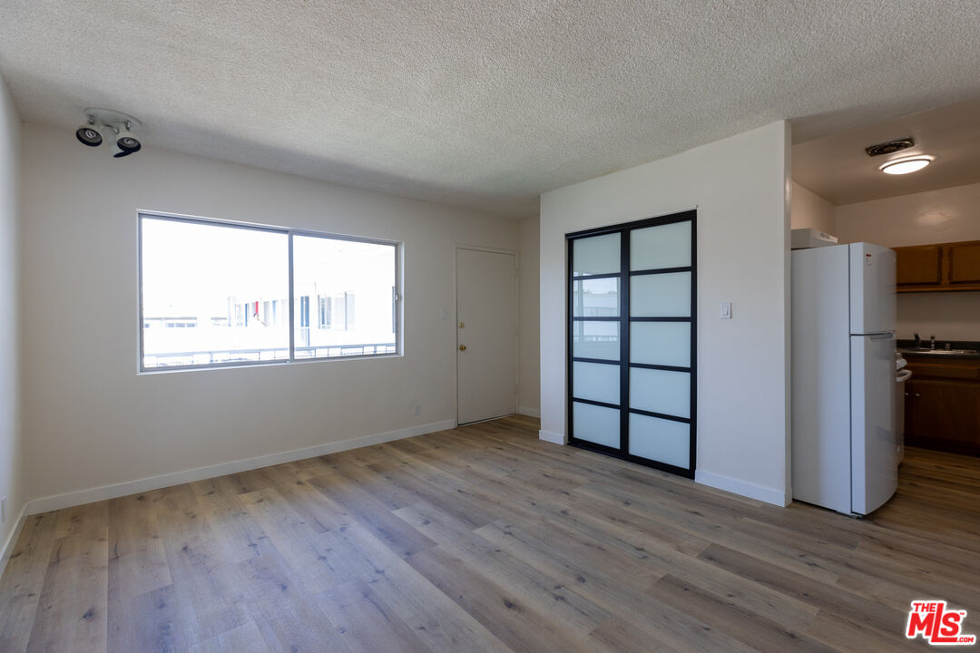 a view of wooden floor and windows in a room