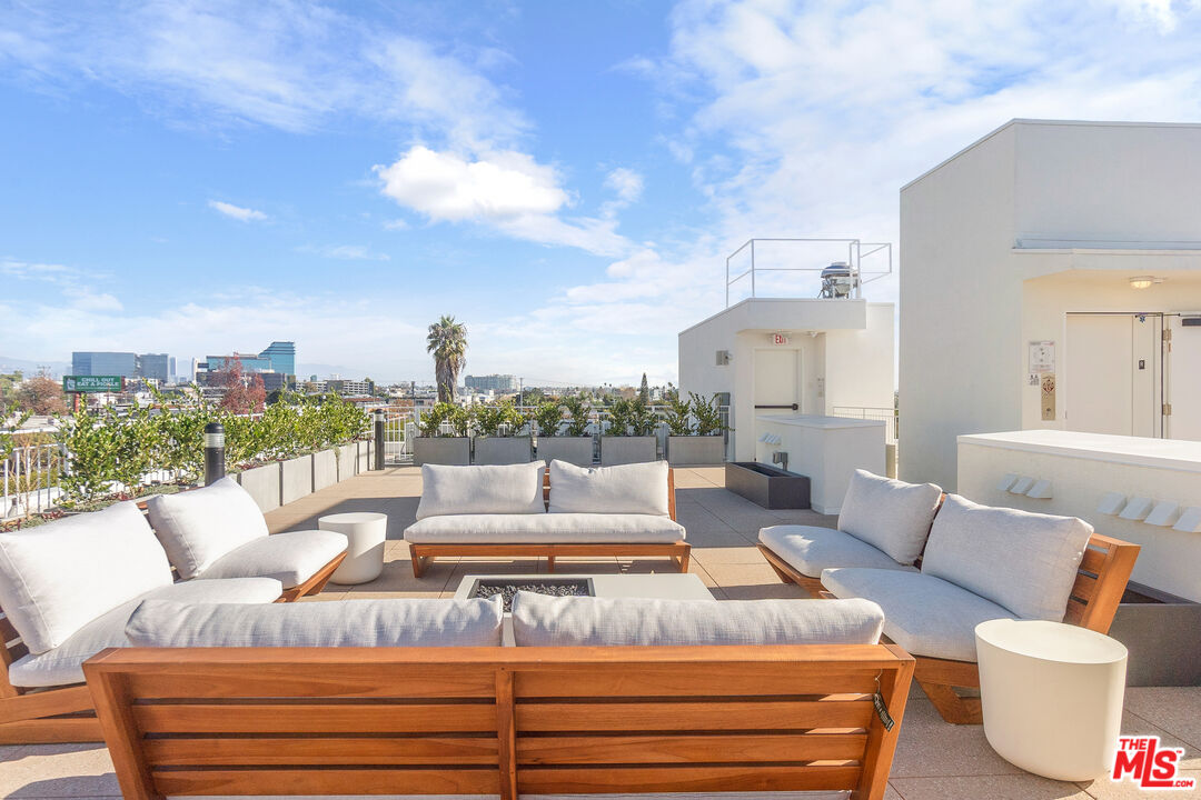 a view of a terrace with couches and a potted plant