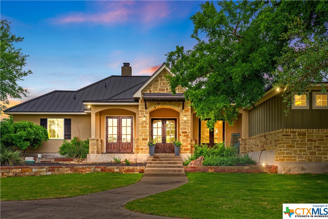 a front view of a house with garden